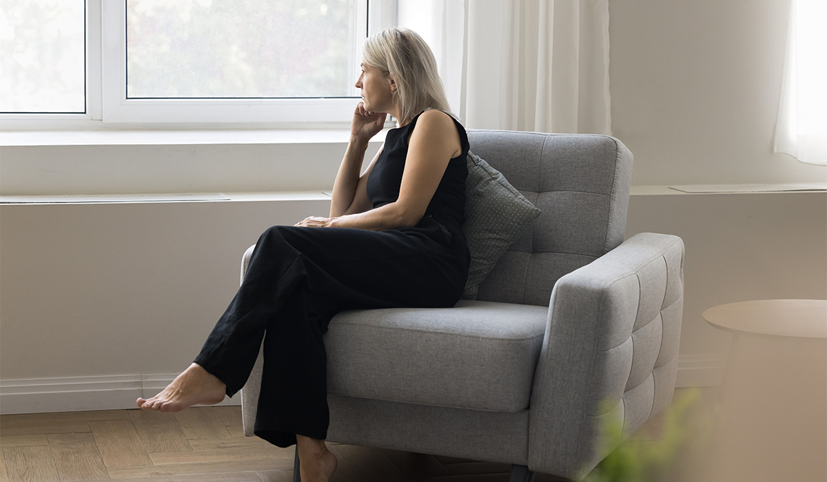 Unhappy mature old lady spend time at home alone look at window lost in dull melancholic thoughts about broken life. Sad depressed older woman suffer from loneliness feel exhausted after hard divorce