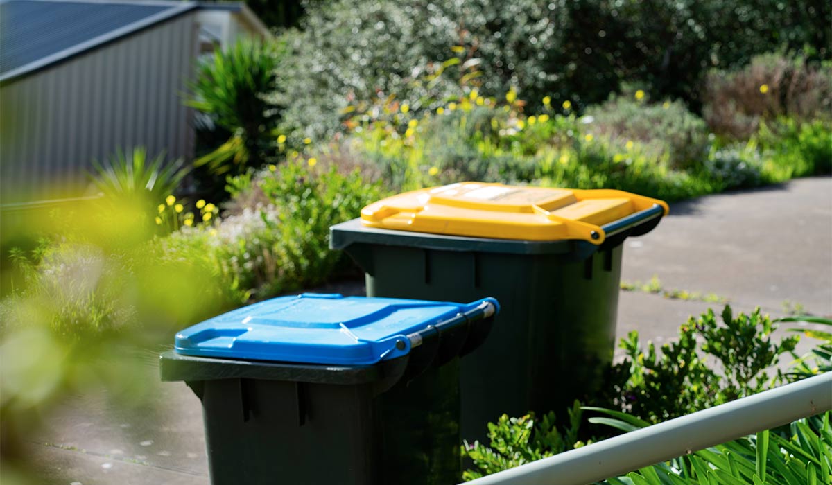 Australian home rubbish bins set provided by local council on back yard in Australian suburb. High quality photo; Shutterstock ID 2334043861; purchase_order: -; job: -; client: -; other: