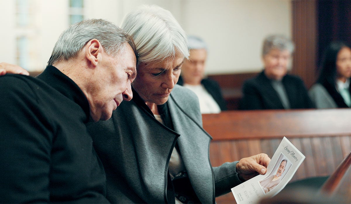 Couple, funeral or sad old man crying in church for God, healing or comfort in Christian community. Elderly woman, depressed or support for an upset mature person in chapel for grief, loss or death; Shutterstock ID 2349948443; purchase_order: -; job: -; client: -; other: