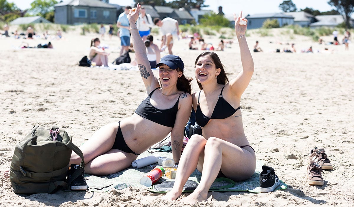 Fiorella Terzano and Austin Canal from Dublin enjoying the hot weather on Burrow Beach, Sutton. Pic: Collins Photos