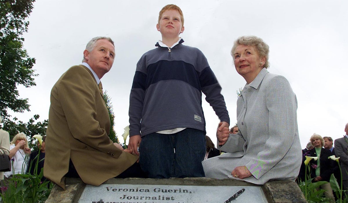 GRAHAM TURLEY, FORMER HUSBAND OF VERONICA GUERIN, CATHAL TURLEY (12), SON OF VERONICA AND BERNIE GUERIN, MOTHER OF THE DECEASED JOURNALIST PICTURED THIS MORNING AT THE UNVEILING OF A MONUMENT TO THE MURDERED JOURNALIST NEAR THE SPOT WHERE SHE WAS SHOT DEAD ON THE NAAS ROAd. Pic: COLIN KEEGAN, COLLINS, DUBLIN