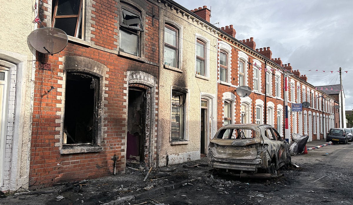 Burned-out cars and houses on Lendrick Street in east Belfast. Pic: PA Wire