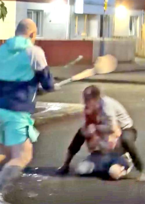 man approaches (LEFT) to try and stop attacker / Sudanese man has been arrested after an attempted 'beheading' in Belfast last night. Officers from the Police Service of Northern Ireland (PSNI) were called to Kinnaird Avenue in the north of the city at around 10.30pm / Source: X