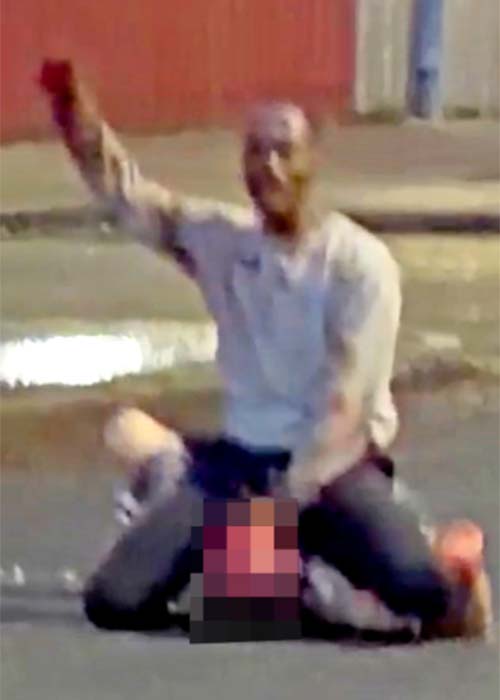 man approaches (LEFT) to try and stop attacker / Sudanese man has been arrested after an attempted 'beheading' in Belfast last night. Officers from the Police Service of Northern Ireland (PSNI) were called to Kinnaird Avenue in the north of the city at around 10.30pm / Source: X