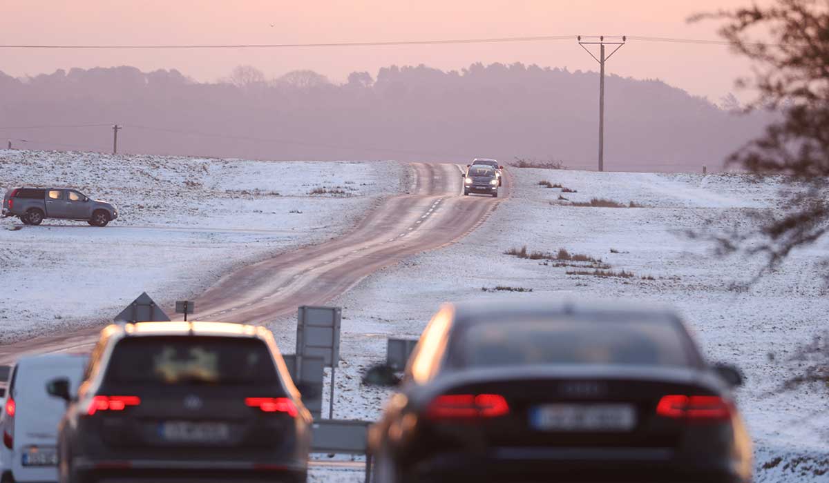 showers 6/1/2025. Kildare, Leinster, Ireland. Commuters head across the icy roads on the snow covered Curragh Plains in County Kildare as dawn breaks. The country is facing into a week of freezing days and nights with very difficult driving conditions. Photo shows the landscape seconds before the sund rises. Photo: Eamonn Farrell/© RollingNews.ie