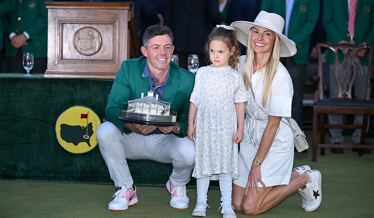 Rory McIlroy of Northern Ireland poses with the trophy, with his family, Poppy McIlroy and Erica Stoll, during the green jacket ceremony, after final round of Masters Tournament at Augusta National Golf Club. pic: Getty Images