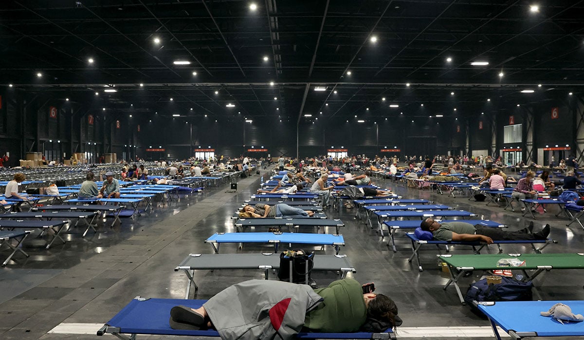 Local residents rest at the Parc des Expositions de Bordeaux after being evacuated due to wildfires in the region. Pic: ALAIN JOCARD / AFP via Getty Images