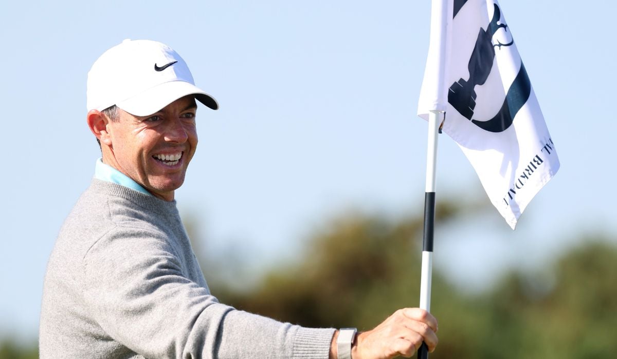 Rory McIlroy of Northern Ireland removes the pin flag on the ninth green during a practice round, prior to The 154th Open Championship at Royal Birkdale on July 14, 2026 in Southport, England. (Photo by Warren Little/Getty Images)