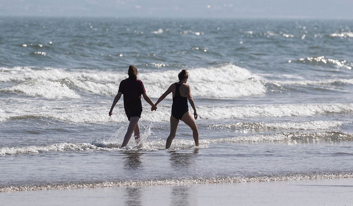 05/09/2023 Beach goers pictuerd this afternoon enjoying the late summer sunshine on Portmarnock Beach, Dublin... Picture Colin Keegan, Collins Dublin