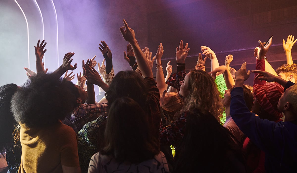 Young people having fun with their arms in the air