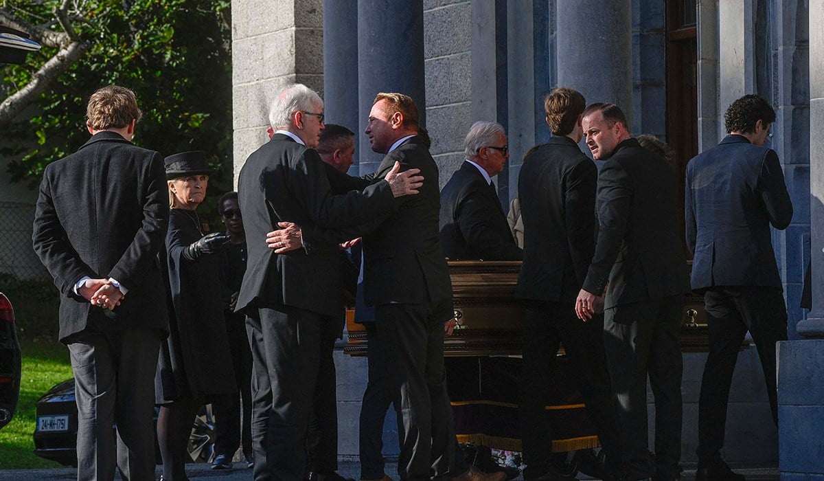 Michael Flatley (centre) greets a mourner as the coffin of his wife Niamh O'Brien arrives for her funeral service at the Church Of St. Therese, Mount Merrion, near Dublin. Picture date: Saturday October 10, 2026. PA Photo. Photo credit should read: Mark Marlow/PA Wire