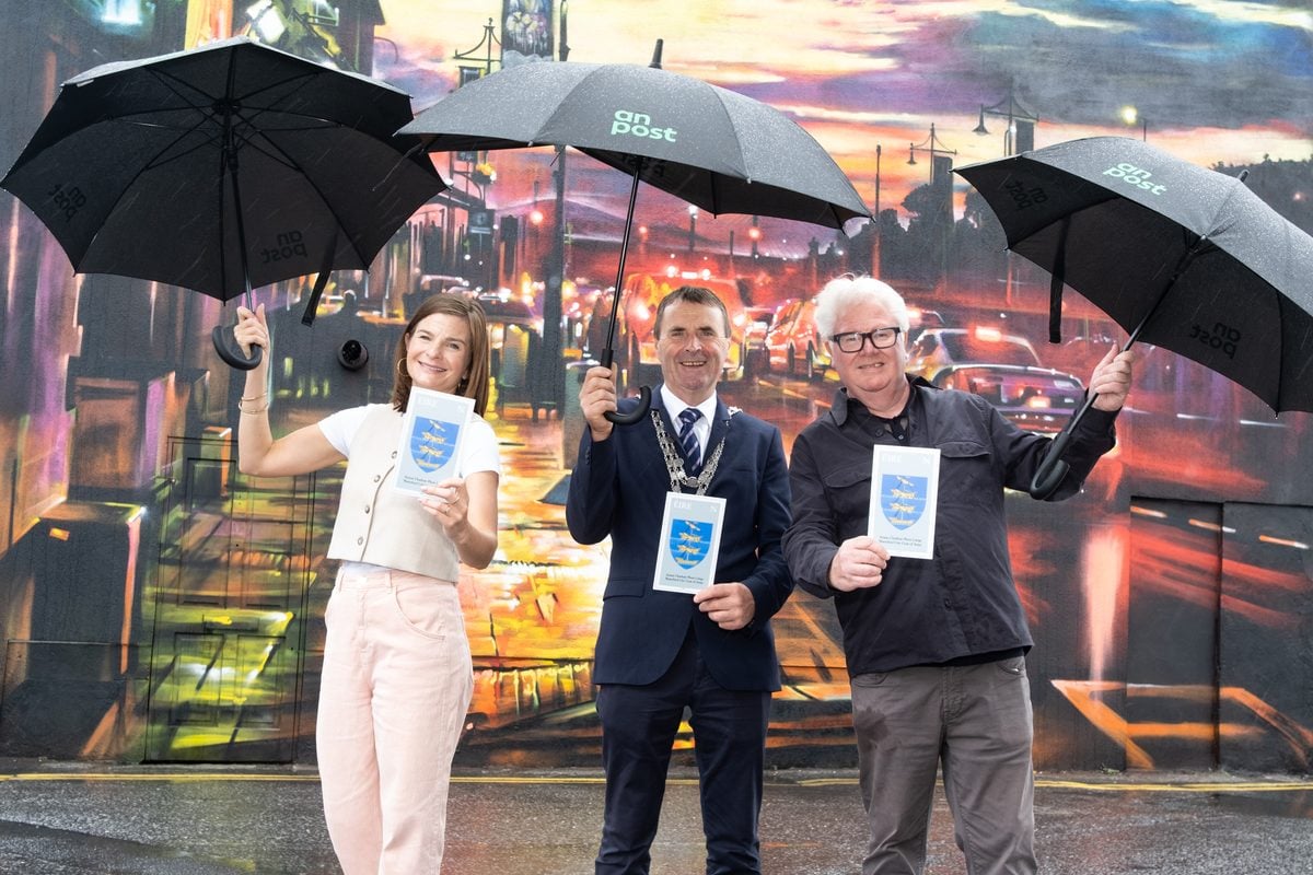 Waterford City Coat of Arms stamp Pippa Halley Waterford Walls Project Lord Mayor Liam Brazil and chef Paul Flynn informal pose stamp blowups at Dan Kitchener mural Tower Hotel