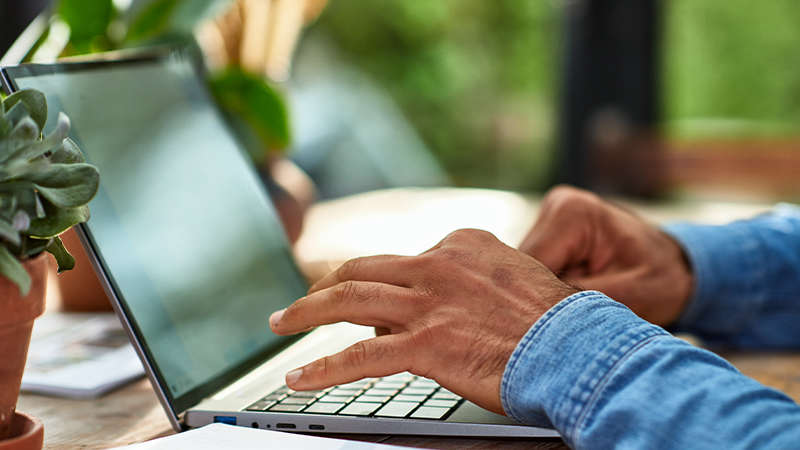 male hands typing on a laptop - getty Images 260124